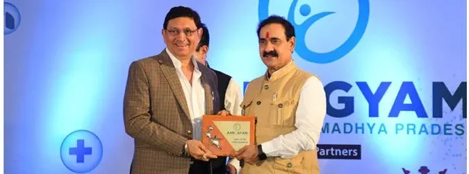 Home Minister Narottam Mishra presenting Aarogyam token